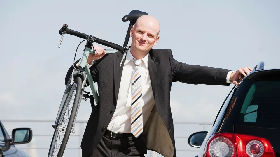 man carrying bike --- Image by © Nils Hendrik Muller/cultura/Corbis