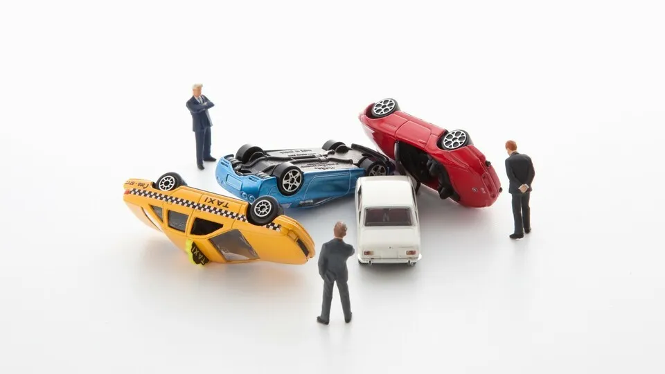 Toy Figure and Cars Are Accident --- Image by © 2/Yasuhide Fumoto/Ocean/Corbis
