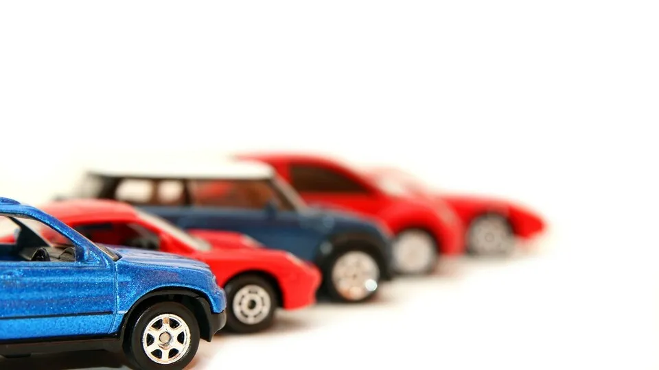 Eine Reihe blauer und roter Autos auf weißem Hintergrund