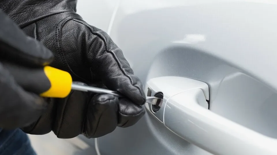 10 Sep 2014 --- Thief breaking into a car --- Image by © Wavebreakmedia LTD/Wavebreak Media Ltd./Corbis